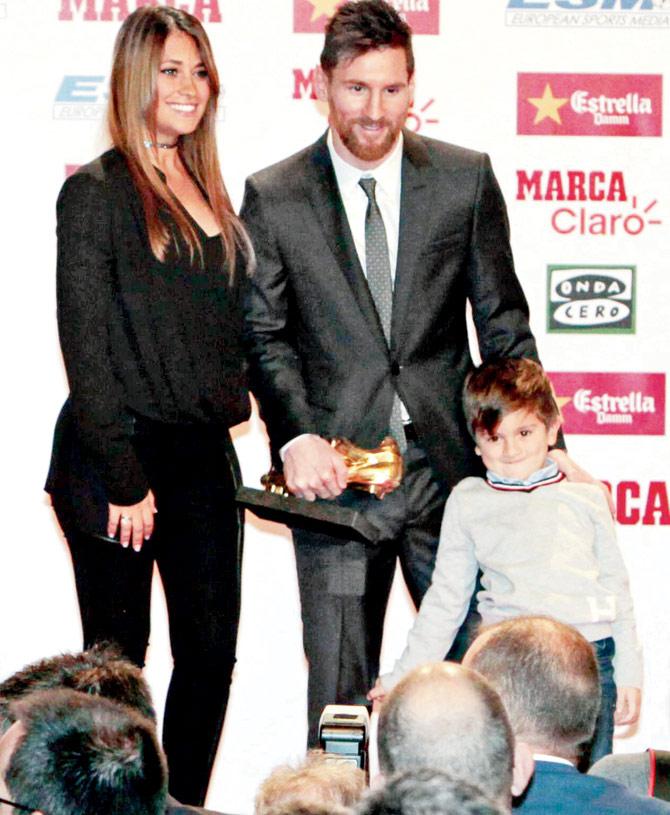 Barcelona star Lionel Messi with his wife Antonella Roccuzzo and their son Thiago after receiving the Golden Boot award at the Old Estrella Damn Factory in Barcelona on Friday. Pic/Getty Images