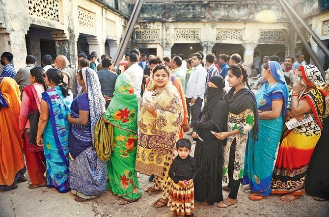 Voters queue to cast their votes at a polling station in Allahabad on Sunday. PIC/PTI