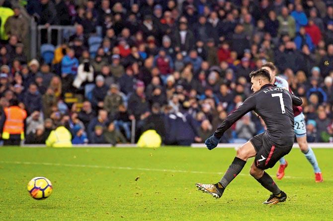 Arsenals Alexis Sanchez scores a penalty during the English Premier League match against Burnley at Turf Moor in Burnley yesterday. Pic/AFP 
