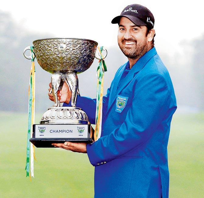 Shiv Kapur poses with the Asian Tour trophy on Sunday. Pic/AFP
