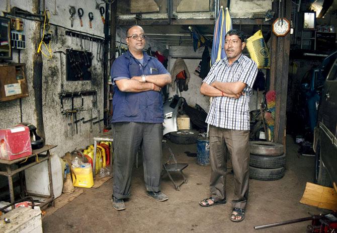 Nilesh Amonkar, seen here with his oldest mechanic Ramesh from Nainital who has been with Sitaram Auto Works for 50 years, feels Forjett Street still retains its basic character. Pic/Ashish Rane