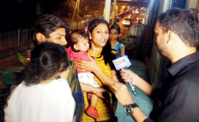 Jyoti Male, who was in the back seat, talks to reporters