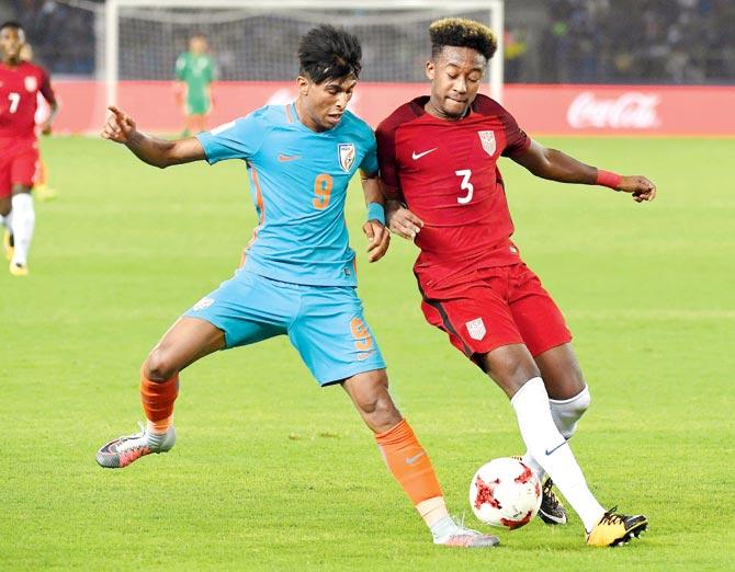 India forward Aniket Jadhav (left) and USA’s Chris Gloster vie for the ball during the FIFA U-17 World Cup tie yesterday. Pic/AFP