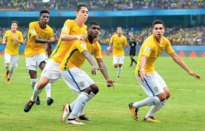 Brazil striker Lincoln (centre) celebrates with teammates after scoring a goal against Spain in Kochi on Saturday. Pic/AFP