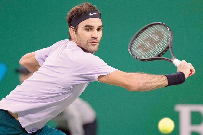 Roger Federer returns to Juan Martin del Potro on Saturday. Pic/AFP