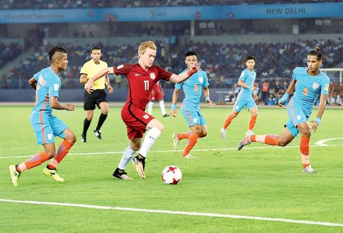 India colts try to gain possession from a USA player during the FIFA U-17 World Cup match at the Jawaharlal Nehru stadium in New Delhi on Friday. Pics/PTI, AIFF