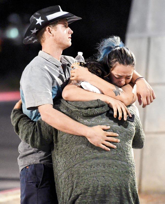 People hug and cry after the mass shooting