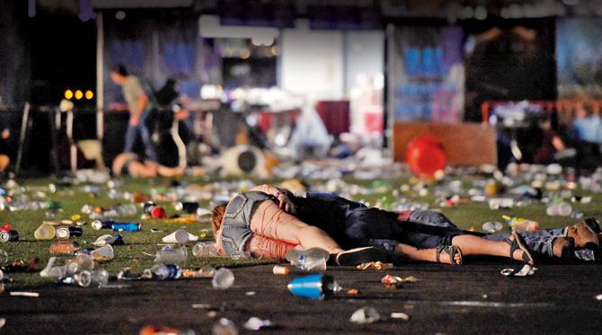 A victim lies on the ground covered with blood at the Route 91 Harvest country music festival after the shootout. Pics/AFP