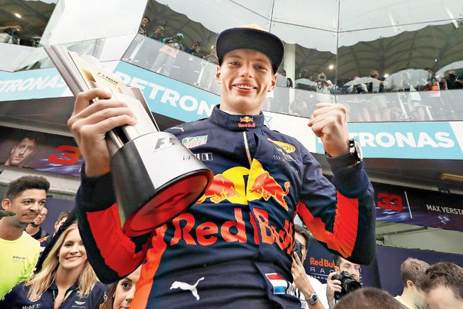 Red Bull driver Max Verstappen celebrates on the podium after winning the Malaysian Grand Prix yesterday. Pic/Getty Images