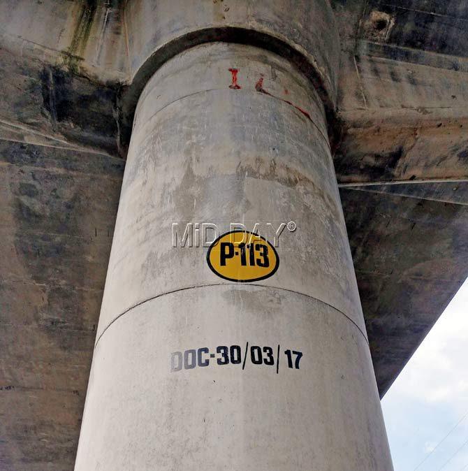 Some of the pillars of the Dahisar-Andheri East Metro corridor, along the Western Express Highway, bearing the completion dates. Pics/Nimesh Dave