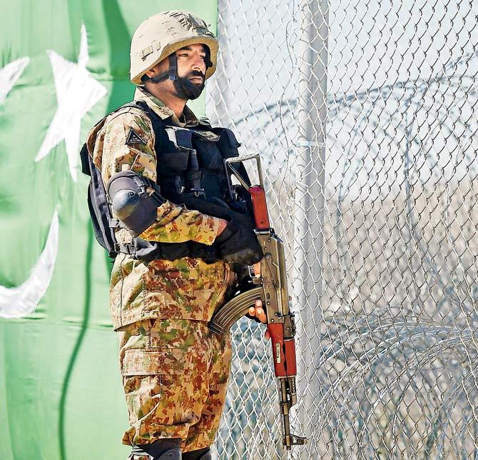 A Pakistani soldier keeps vigil next to a newly fenced border along Paktika province. Pic/AFP