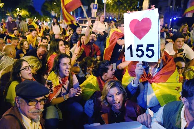 Protesters with Spanish flags shout slogans in favour of Spanish Constitution and the implementation of its 155 article, during a demonstration defending a united Spain in Barcelona. Pic/AFP