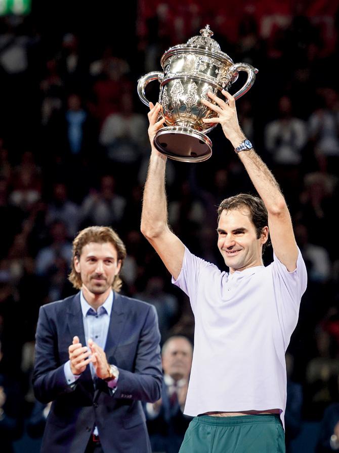 Roger Federer with the Swiss Indoors trophy yesterday. Pic/AFP