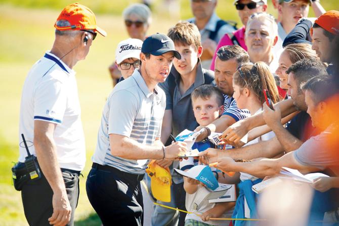 Rory McIlroy signs autographs for golf fans at Royal Birkdale in Southport, England this July. Pic/Getty Images