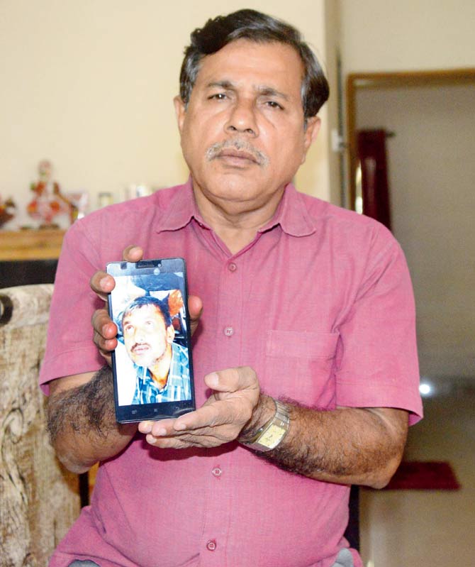 Shekharan Balan shows a picture of one of the accused, Ranjeet Mishra, who allegedly assaulted him. Pic/Hanif Patel