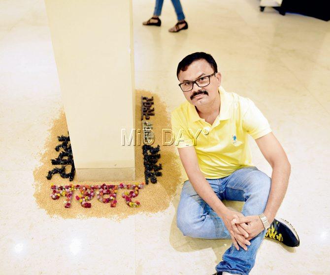 Artist Lalit Patil seen with his iconic installation of the Hindi word Nashwar (mortal) in which he has recycled rusted iron left-overs and manually segregated ornate metal cut-outs to underline impermanence. Pics/Bipin Kokate