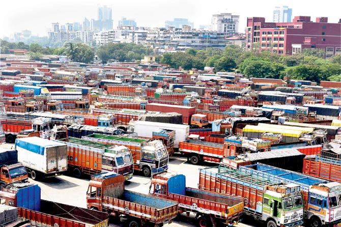 Truck operators leave their vehicles parked at the Vashi APMC in Navi Mumbai during their strike against GST (Goods and Services Tax) on Monday. Pic/PTI