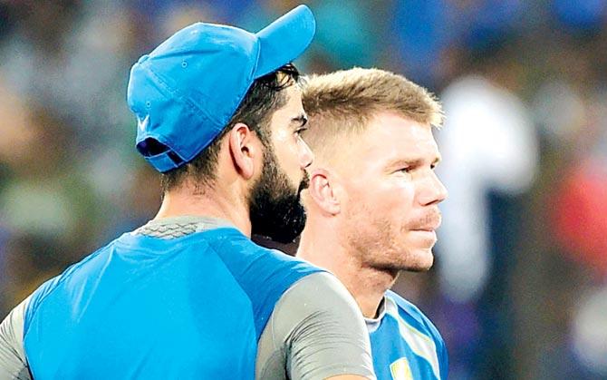 Opposing skippers Virat Kohli and David Warner show their frustration at the wet conditions in Uppal yesterday. Pic/PTI