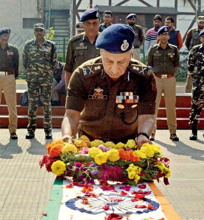 DG of J&K Police SP Vaid pays tribute to Constable Zahir Abbas Khan who was killed in the encounter. Pic/PTI