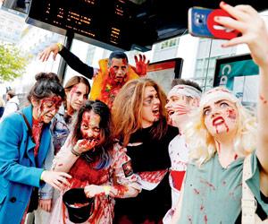 World Zombie Day: People pose for selfie before heading for a 'Zombie Walk'