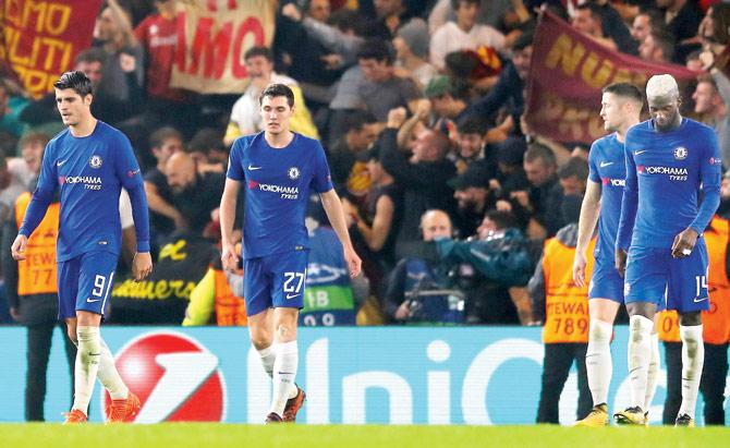 Chelsea players wear a dejected look after conceding a goal against Roma in the Champions League match on Wednesday. Pic/Getty Images