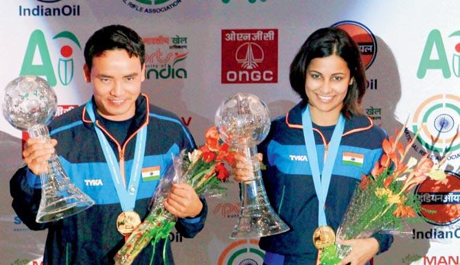 India shooter Jitu Rai (left) and Heena Sidhu pose with their gold medals after winning the mixed team 10m air pistol event at the  ISSF World Cup final at New Delhi yesterday. The duo shot 483.4 points to finish first on the podium. Pic/PTI