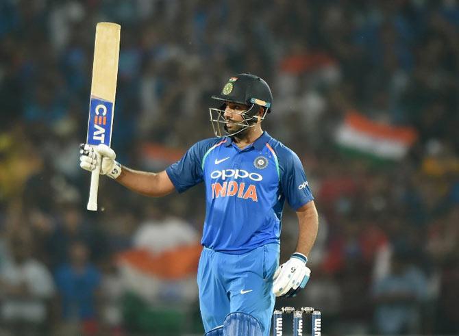 Indian cricketer Rohit Sharma celebrates after scoring a century (100 runs) during the fifth one-day international cricket match against India at the Vidarbha Cricket Association Stadium in Nagpur. AFP Photo