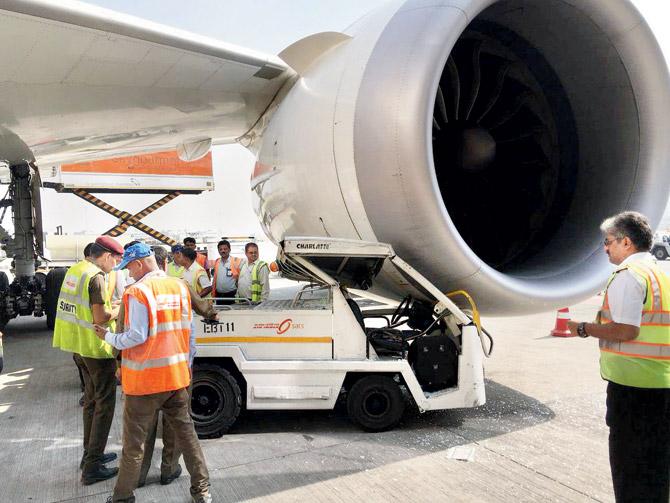 An electronic baggage tow tractor on Saturday collided into an Air India (AI)âÂÂu00c2u0080ÂÂu00c2u0088pla­ne at Indira Gandhi International (IGI) airport dela­ying a flight to Shanghai by 45 minutes