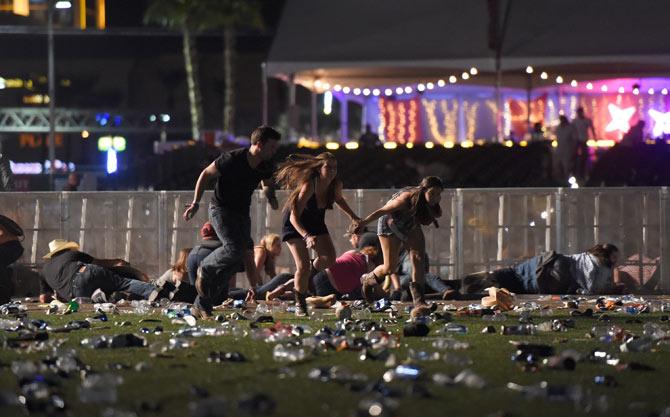 People run from the Route 91 Harvest country music festival after apparent gun fire was heard