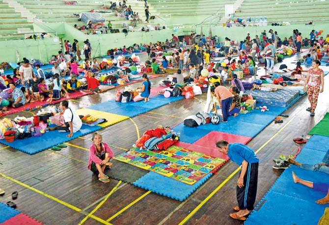 People wait inside an evacuation centre in Klungkung regency, on the Indonesian resort island of Bali on Monday. Pic/AFP