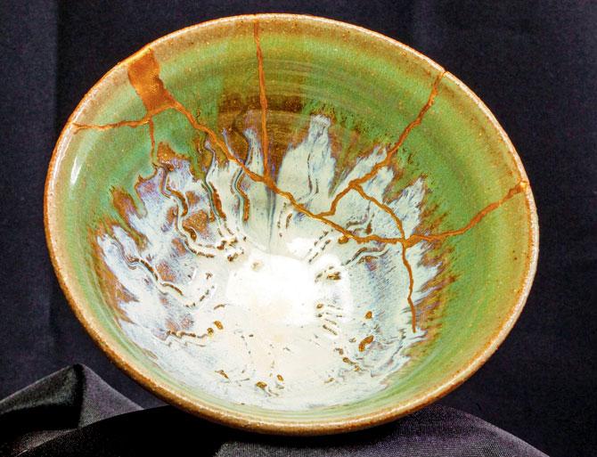 A broken bowl repaired with the art of Kintsugi using powdered gold