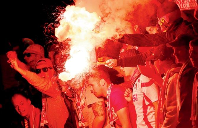Cologne fans light flares inside the stadium on Thursday. Pic/AFP