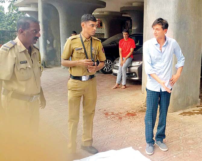 The constable (second from left), who conducted the preliminary spot check after Karan Joseph fell to death from Concorde Apartment, with Rishi Shah (in blue trousers)