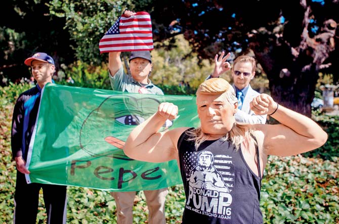 A man wears a Donald Trump mask after conservative commentator Milo Yiannopoulos spoke to a crowd of supporters on the University of California, Berkeley campus, on Sunday. Pic/AFP