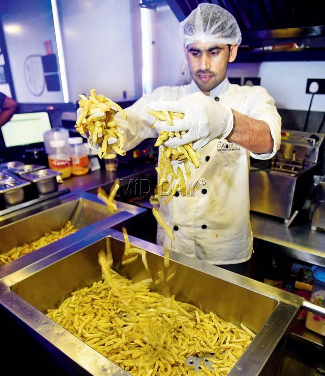 A staffer preps the fries in the kitchen