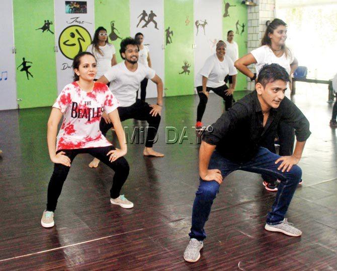 Squats with claps help strengthen your lower body; founder Satyajit Vora (in black)