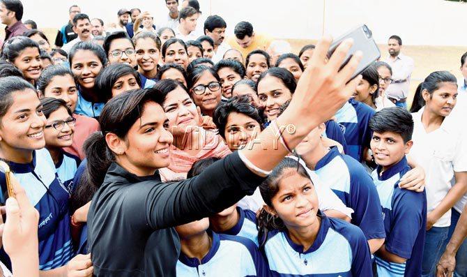 Harmanpreet Kaur takes a selfie with Punam Raut and budding cricketers in Kandivli on Saturday. Pic/Shadab Khan
