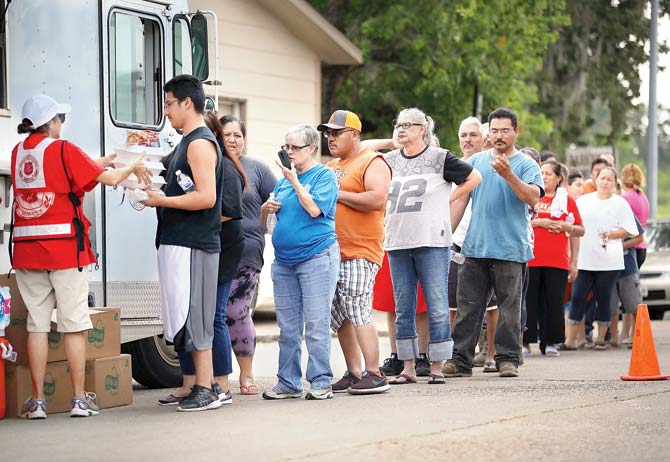 People line up to receive food and water during Hurricane and Tropical Storm Harvey in Houston. Pic/Getty Images/AFP