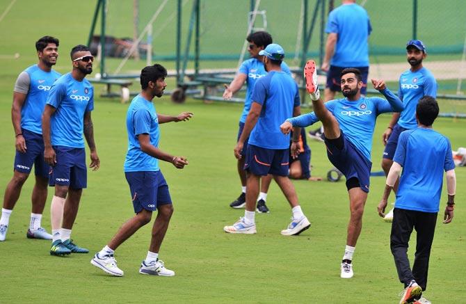 Indian cricket team captain Virat Kohli (3R) plays football with his team mates during a practice session ahead of the fourth One Day International (ODI) match of the ongoing India-Australia cricket series at the M. Chinnaswamy Stadium in Bangalore on September 26, 2017. Pic/AFP