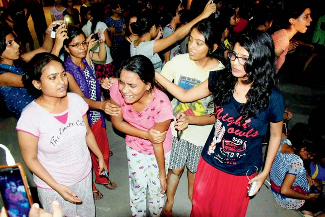 An injured student writhes in pain after the police beat them up during the clash at Banaras Hindu University