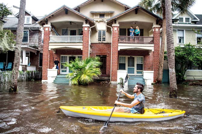 Justin Hand navigates storm surge flood waters in Jacksonville, Florida. Pic/AFP