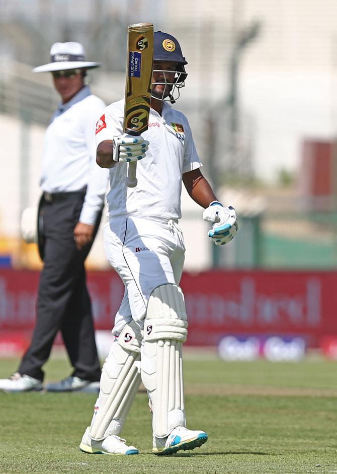 Dimuth Karunaratne of Sri Lanka celebrates after his half century on the first day of the first Test cricket match between Pakistan and Sri Lanka at Sheikh Zayed Stadium in Abu Dhabi on September 28, 2017. Pic/AFP