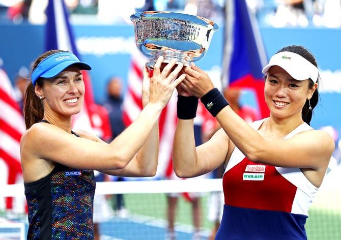 Martina Hingis of Switzerland and Yung-Jan Chan of Taiwan hold the championship trophy after defeating Lucie Hradecka of Czech Republic and Katerina Siniakova of Czech Republic after their Women