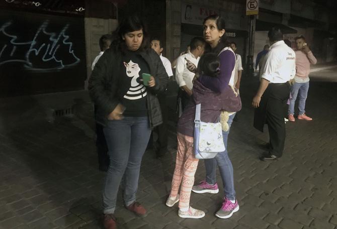 People walk along a street in downtown Mexico City during an quake, on September 7, 2017. An earthquake of magnitude 8.0 struck southern Mexico late Thursday and was felt as far away as Mexico City, the US Geological Survey said, issuing a tsunami warning. It hit offshore 120 kilometers (75 miles) southwest of the town of Tres Picos in the state of Chiapas. Pic/AFP