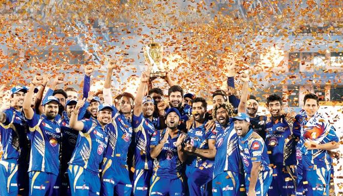 Mumbai Indians players hold the Indian Premier League trophy as they celebrate their victory against Rising Pune Supergiant after the IPL final at Hyderabad in May this year. Pic/AFP