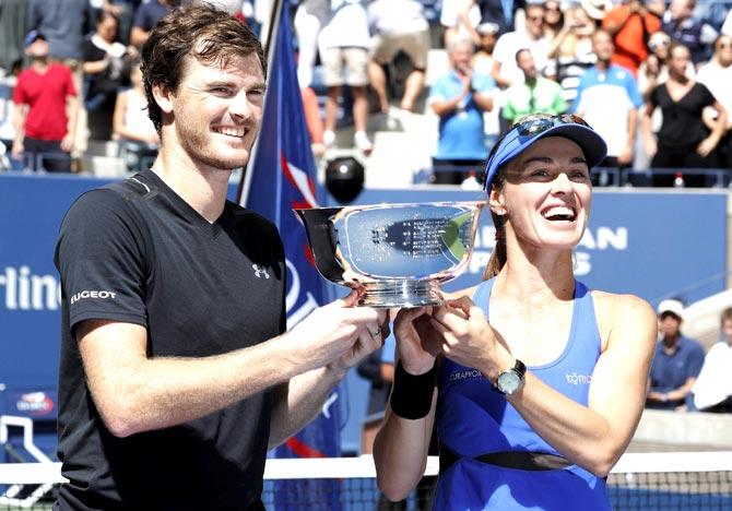Martina Hingis, of Switzerland, right, and Jamie Murray, of Great Britain, hold up the championship trophy after winning the mixed doubles final of the U.S. Open tennis tournament against Chan Hao-Ching, of Taiwan, and Michael Venus, of New Zealand in New York. Pic/AFP