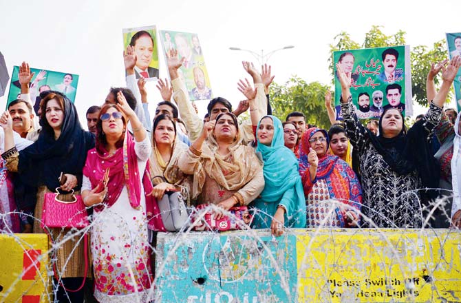 Supporters of Nawaz Sharif hold placards as they shout slogans outside an accountability court where he appeared to face corruption charges. Pic/AFP