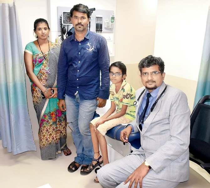 Om Gupta with his parents and Dr Bipeenchandra Bhamre (seated)