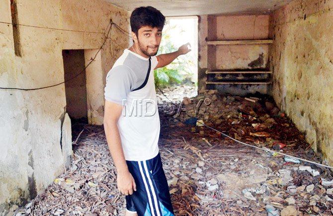 Srived Datta, 24, points to the ground floor flat in Kalina’s Air India Colony where a house help drowned when the water level rose to 10 feet, while she was trying to save some residents. He says nightmares surrounding the accident continue  to plague him. Pic/Dutta Kumbhar