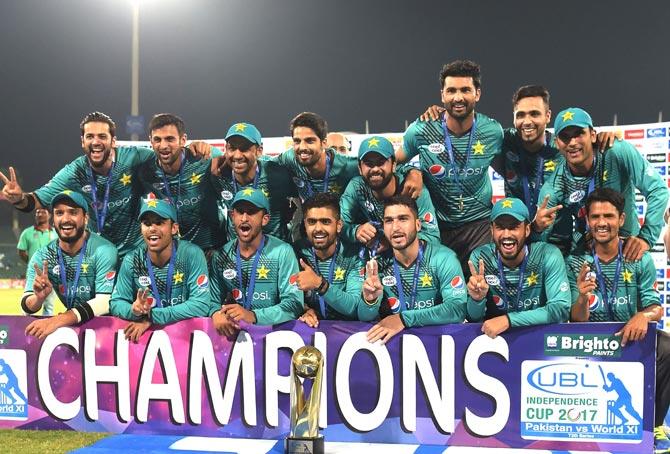 Pakistani cricketers pose for a photograph with trophy after winning the third and final Twenty20 International match against World XI at the Gaddafi Cricket Stadium in Lahore. Pic/AFP